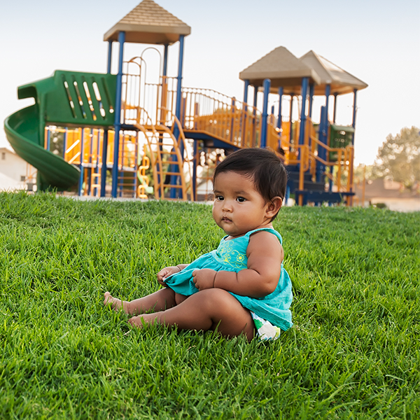 Baby sitting in grass