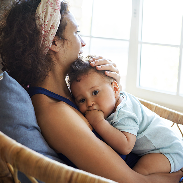 Mother holding baby on chair