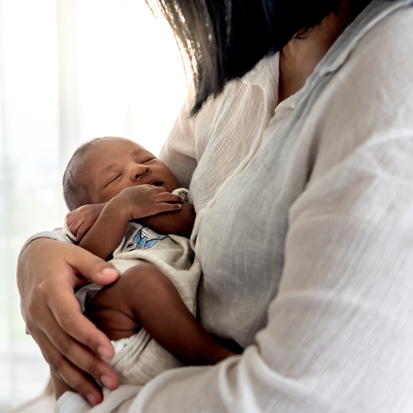 600x600_newborn in caretaker arms